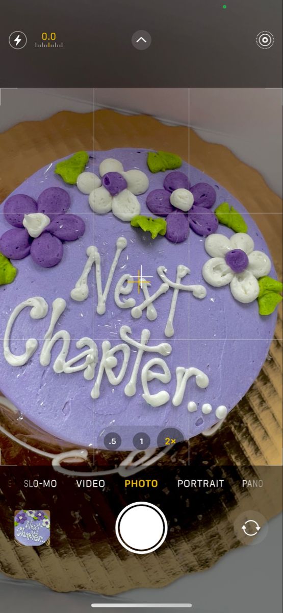 a purple cake with white frosting and flowers on the top that says next charter