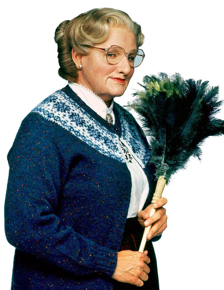 an older woman wearing glasses and holding a feathered stick