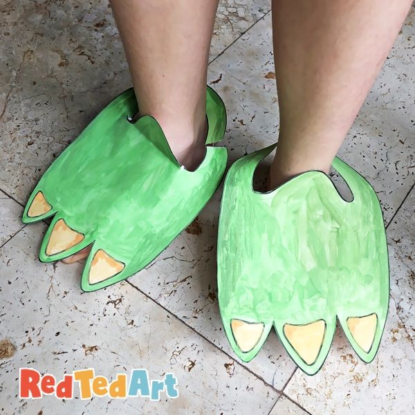 the legs of a person wearing green shoes with yellow spikes on their feet and one foot sticking out