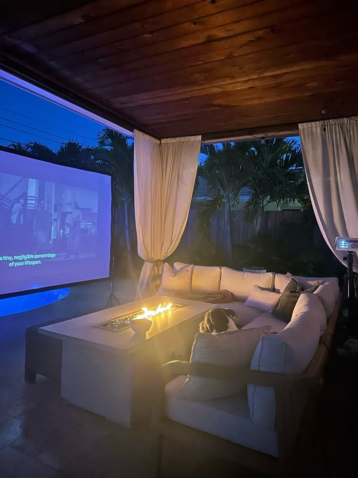 a living room filled with furniture and a projector screen