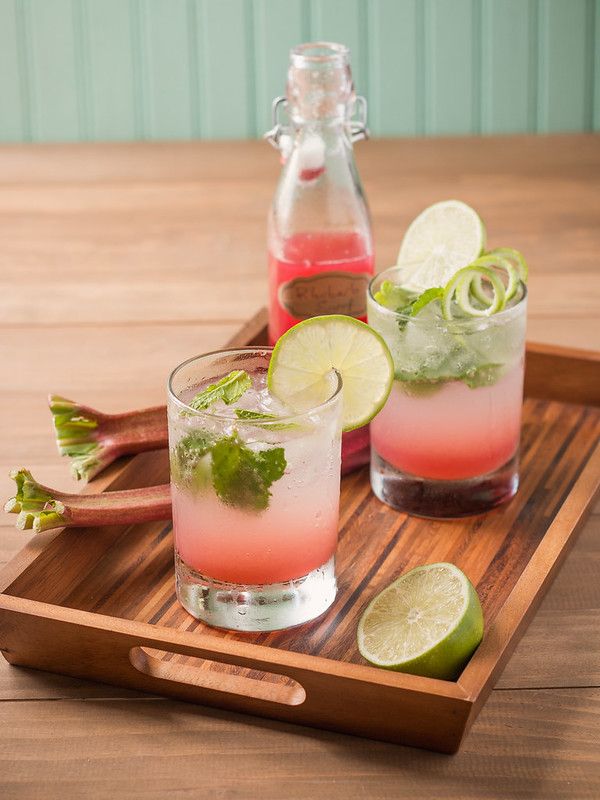 two glasses filled with watermelon and lime on a wooden tray