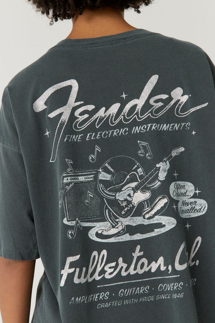 Site of Fender’s original factory, Fullerton CA was needless to say home to countless iconic guitars that transformed nearly every music genre. Because Fender slapped “Fullerton, California” on each of their stringed instruments, their headquarters became known worldwide. Illuminated in silver glitter, Fender’s merch tee lights up their musical contribution over the years with a guitar playing record graphic and feature of their household name. A blend of our Weekend Tee and OS Tee, this tee is Record Graphic, Guitar Playing, Faux Leather Top, Music Genre, Stringed Instruments, Ladder Stitch, Champion Sweatshirt, Rainbow Kids, Tour Shirt