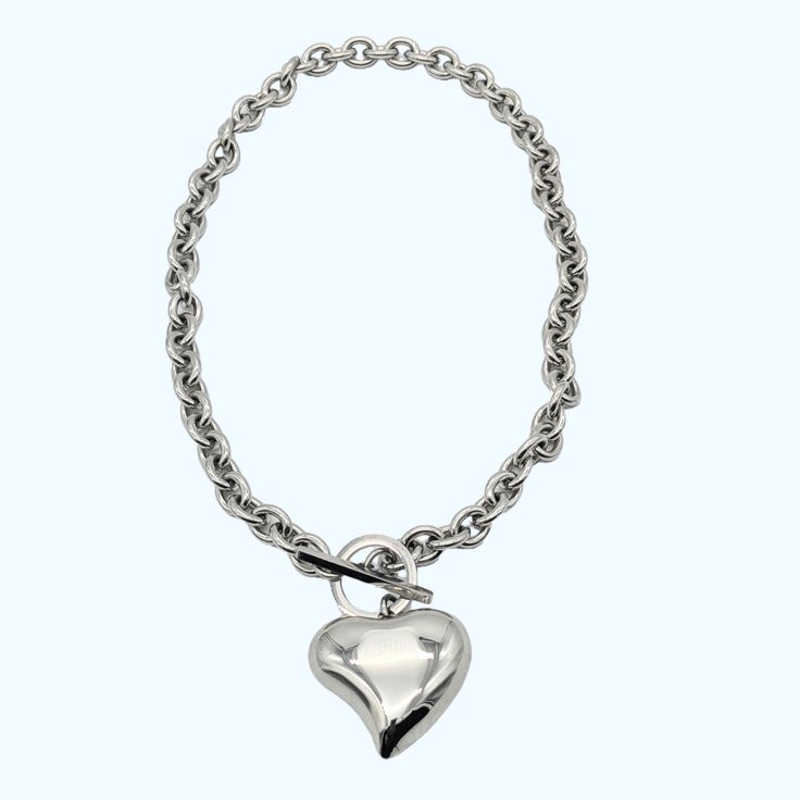 Curved Heart Pendant Statement Necklace with toggle clasp closure - "Add a touch of love to your wardrobe with this necklace! Featuring a unique curved heart pendant and a secure toggle clasp, you'll be sure to stand out in style. Say 'I heart fashion' with this playful and versatile accessory. (Warning: May cause uncontrollable amounts of heart eye emojis from your friends and admirers.)" Metal - 18k Goldplated for gold Silverplated for silver color Waterproof Chain length: 46 cm Heart-shaped Chunky Chain Necklace For Valentine's Day, Valentine's Day Heart-shaped Chunky Chain Necklace, Metal Heart Necklace With Chunky Chain, Heart Pendant Necklace With Chunky Chain, Valentine's Day Heart Necklace With Chunky Chain, Metal Heart Necklace With Open Heart Charm, Heart Necklace With Lobster Clasp For Everyday, Heart Shaped Chunky Chain Necklace, Everyday Heart Necklace With Lobster Clasp