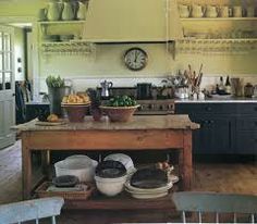 an old fashioned kitchen with pots and pans on the island