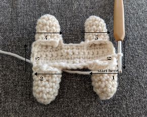 the crocheted object is next to a knitting needle with measurements for each stitch