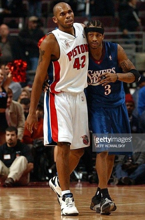 two basketball players standing next to each other on a court