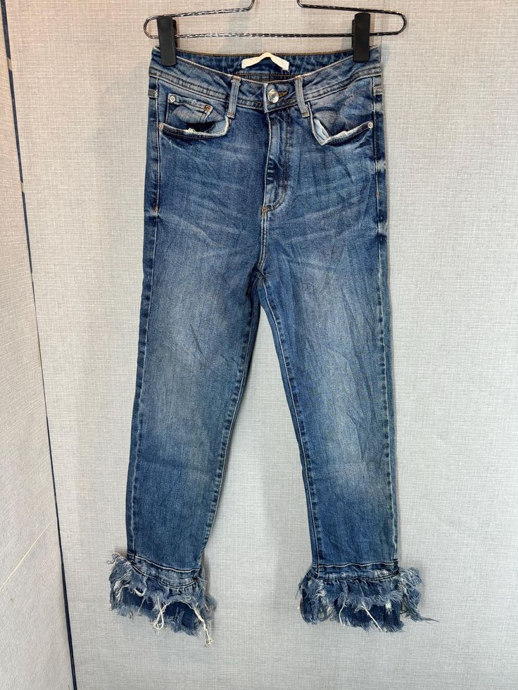 This pair of Zara jeans features a medium wash denim with a worn-in, slightly faded look. The jeans have a classic five-pocket design with visible stitching around the pockets and waist. One of the standout details is the frayed, distressed hem at the ankles, which adds a trendy, casual flair. The overall style is modern and edgy, perfect for a laid-back, fashionable look. * Accept any kind of Payment method through ETSY only- * Please CHECK measurement & photos CAREFULLY. * All sales are FINAL, Denim Flare Jeans With Frayed Hem For Fall, Dark Wash Denim Flare Jeans With Frayed Hem, Denim Blue Cropped Jeans With Frayed Hem For Fall, Fall Cropped Denim Blue Jeans With Frayed Hem, Dark Wash Straight Leg Jeans With Frayed Hem, High Rise Dark Wash Cropped Jeans With Frayed Hem, Fall Cropped Denim Jeans With Frayed Hem, Fall Cropped Jeans With Frayed Hem, Denim Flare Jeans With Frayed Hem In Medium Wash