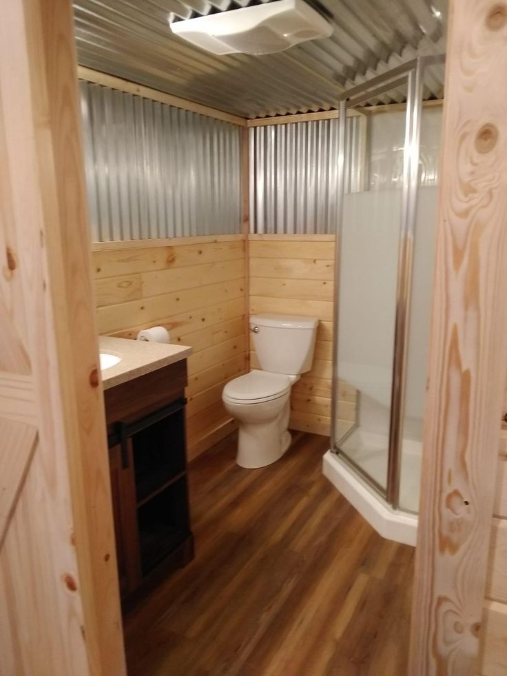 a bathroom with wooden floors and walls