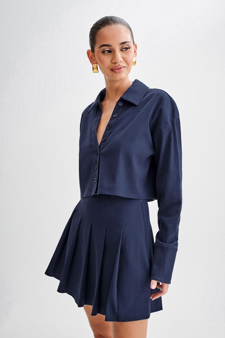 Buttoned and ready. Introducing the JULIANNA Cotton Button Up Shirt in Navy, a versatile staple for every wardrobe. With its collared neckline and functional center front placket with button closure, this shirt exudes timeless sophistication. The cropped length adds a modern twist, while long sleeves and functional cuffs offer both style and practicality. Crafted from breathable, unlined cotton, it ensures comfort all day long. Complete with a back inverted box pleat and back yoke details, this Inverted Box Pleat, Box Pleats, Button Up Shirt, Latest Fashion Trends, Latest Fashion, Button Up Shirts, Button Up, Long Sleeves, Twist