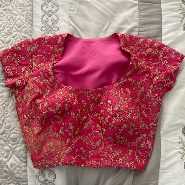 New, Never Worn. I Did Have It Taken In From The Back But These Stitches Can Be Removed To Make The Blouse Larger. Built In Bra Cups. Side Zipper. Material Is Slightly Discolored But Was Purchased This Way And Not Super Noticeable Pink Short Sleeve Festive Blouse Piece, Festive Pink Short Sleeve Blouse Piece, Fitted Pink Blouse With Zari Work, Pink Short Sleeve Blouse For Festive Occasion, Festive Pink Short Sleeve Blouse, Fitted Pink Top With Zari Work, Pink V-neck Blouse For Festive Occasions, Fitted Pink Blouse For Festive Occasions, Pink V-neck Tops For Festive Occasions