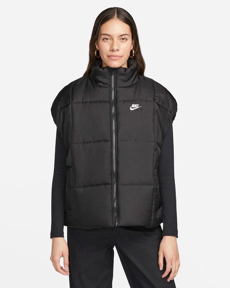 NEW WITH TAGS! $110 Nike Sportswear Women's Classic Puffer Therma-FIT Loose Vest size: Small color: Black 100% polyester Warm enough to keep you comfortable but light enough to keep you on the go, this loose puffer vest is the perfect layering piece. Lightweight insulation paired with Nike Therma-FIT technology manages your body's natural heat to help keep you warm on chilly days. Zip it all the way up for extra coverage and slip your hands in the pockets when they need a break from the cold. FIT & DESIGN: Nike Therma-FIT technology helps manage your body’s natural heat to help keep you warm in cold-weather conditions Water-repellent finish helps keep you dry in wet weather Bungee toggles at the waist let you easily adjust your fit Warm, hip-length vest with loose fit Water-repellent fabri Nike Puffer Vest, Nike Vest, Loose Vest, Nike Sportswear Women, Oversized Vest, Black Puffer Vest, Running Vest, Black Puffer, Black Vest