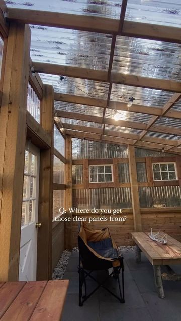 a wooden bench sitting under a pergolated roof