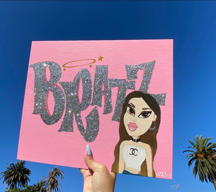 a person holding up a pink sign with the word booze on it and a woman's face