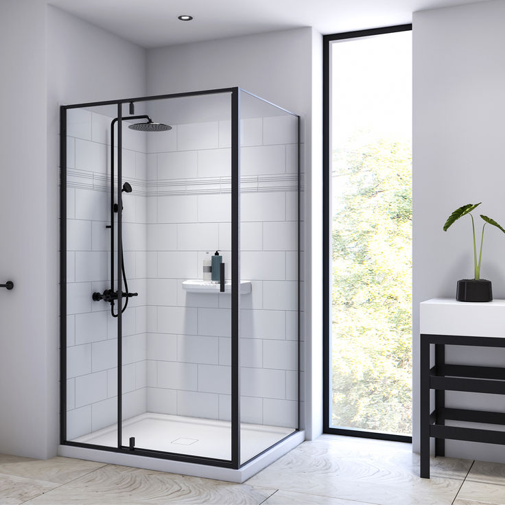 a bathroom with a walk in shower next to a white sink and black framed mirror