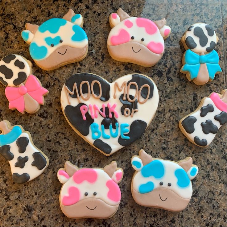 decorated cookies are arranged in the shape of cows and heart shaped cow's heads