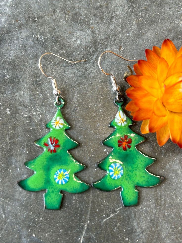 These fun festive earrings are sure to bring smiles even on the darkest of days! I'm Lucy, from Canny Goose - a Cornwall based jeweller and workshop host.  All my jewellery is handmade by me, in my eco studio in St Austell, right in the middle of Cornwall.  These enamel earrings are made using lead-free enamel on copper.  Featuring sterling silver ear wires, the earrings dance around beautifully in their gorgeous array of colours and bring smiles and laughter in abundance.  A wonderful fun gift Earrings Dance, Festive Earrings, Tree Earrings, Christmas Tree Earrings, Eco Gifts, Earring Tree, Enamel Earrings, Christmas Earrings, Cornwall