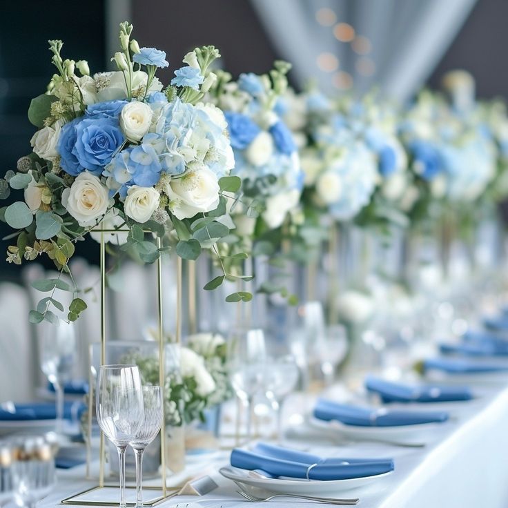 a long table is set with blue and white flowers