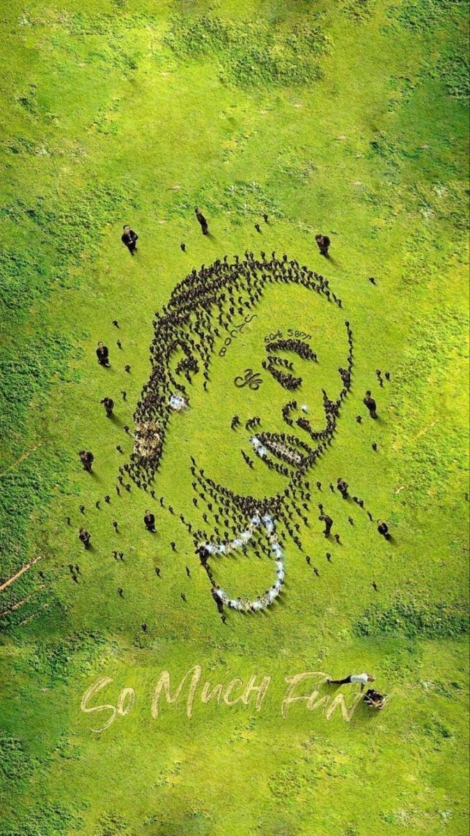 an image of a man's face in the grass with words written on it