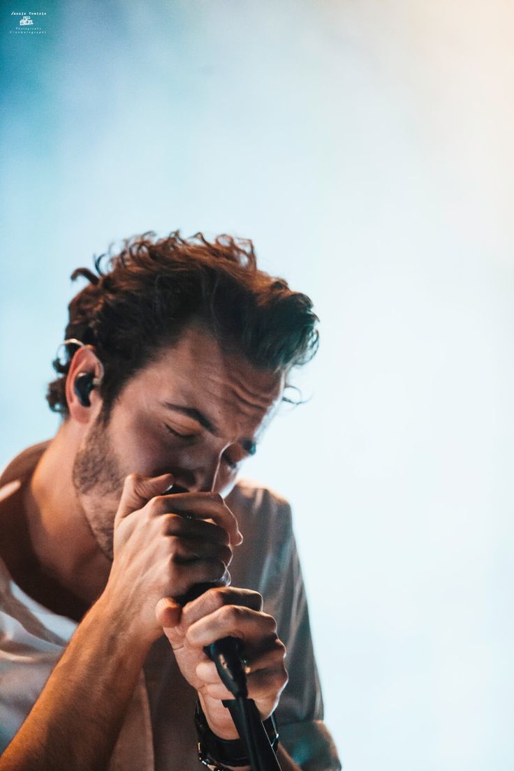 a man holding a microphone up to his face