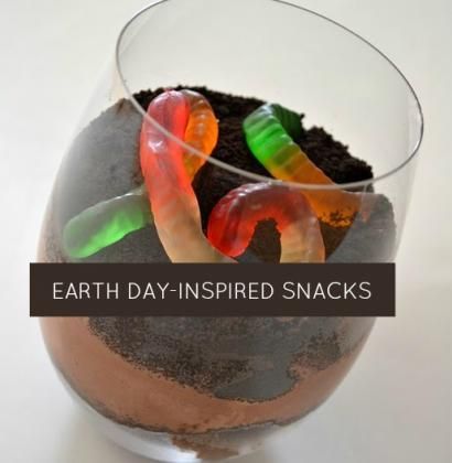 an earth day - inspired snack in a glass bowl with gummy worms and dirt