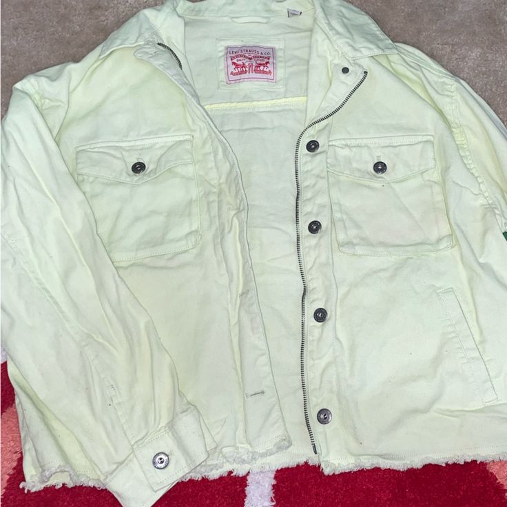 Super Pale Mint Green With A Hint Of Yellow Oversized Levi Jacket. Never Worn, Kept In A Drawer. Fuzz On Back Has Been Removed, Just Due To Being Folded. Raw Bottom Hem. Zipper Is Just For Style, Does Not Zip. Spring Yellow Tops With Pockets, Yellow Denim Jacket With Pockets For Fall, Yellow Cotton Denim Jacket With Pockets, Yellow Spring Outerwear With Pockets, Spring Yellow Outerwear With Pockets, Relaxed Fit Yellow Outerwear With Pockets, Yellow Relaxed Fit Outerwear With Pockets, Casual Yellow Denim Jacket With Pockets, Yellow Cotton Denim Jacket For Fall