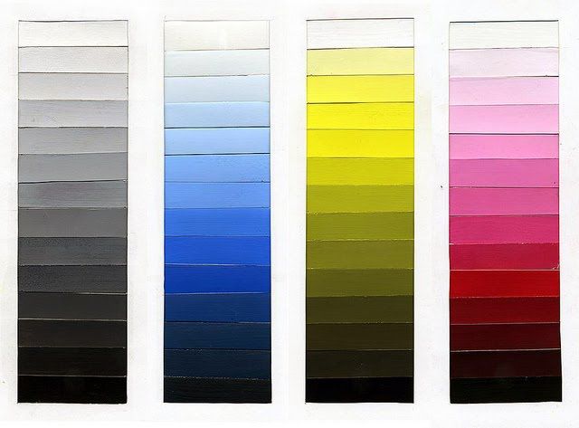 four different colors of paint are shown in the same color scheme as each one is black, white, yellow, red, blue, and green