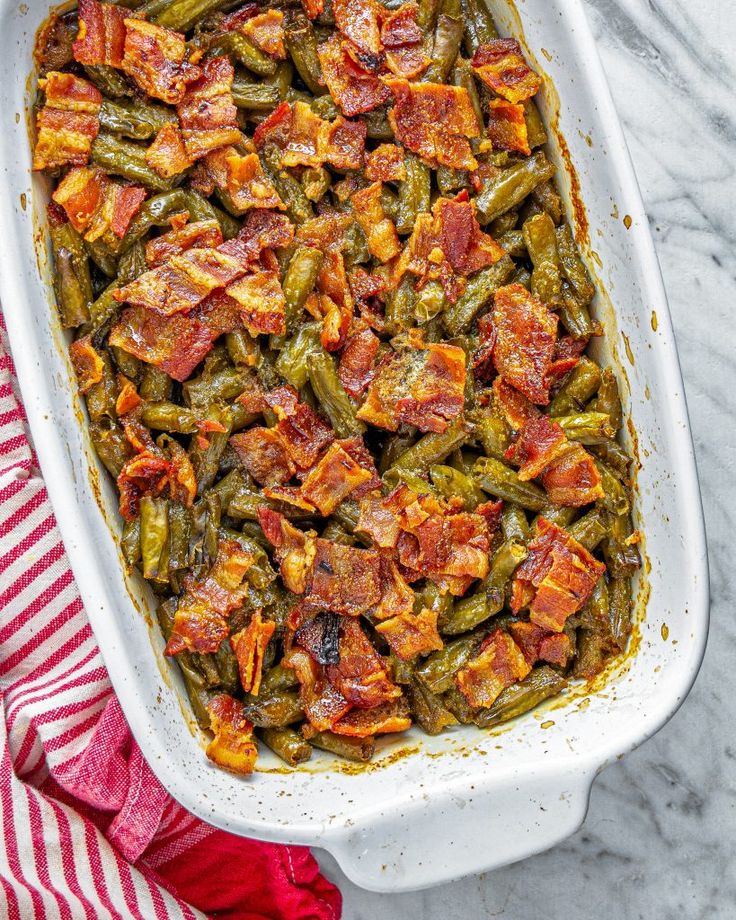 a casserole dish filled with green beans and bacon