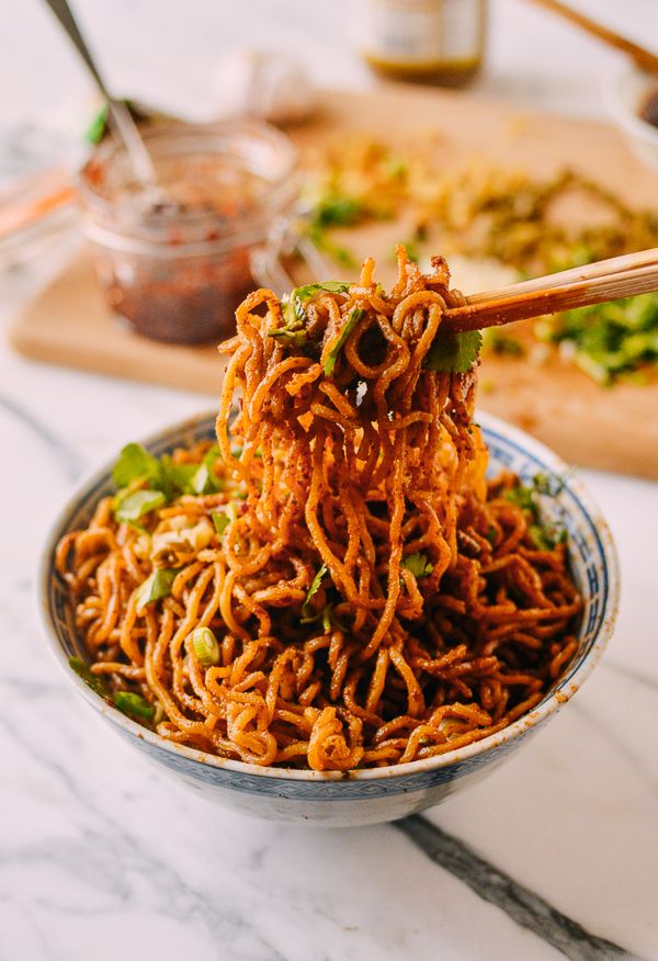 noodles in a bowl with chopsticks sticking out of the top and another dish on the side