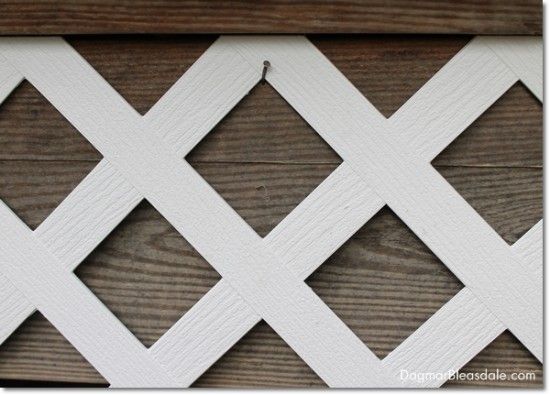 a close up of a wooden fence with white paint on it