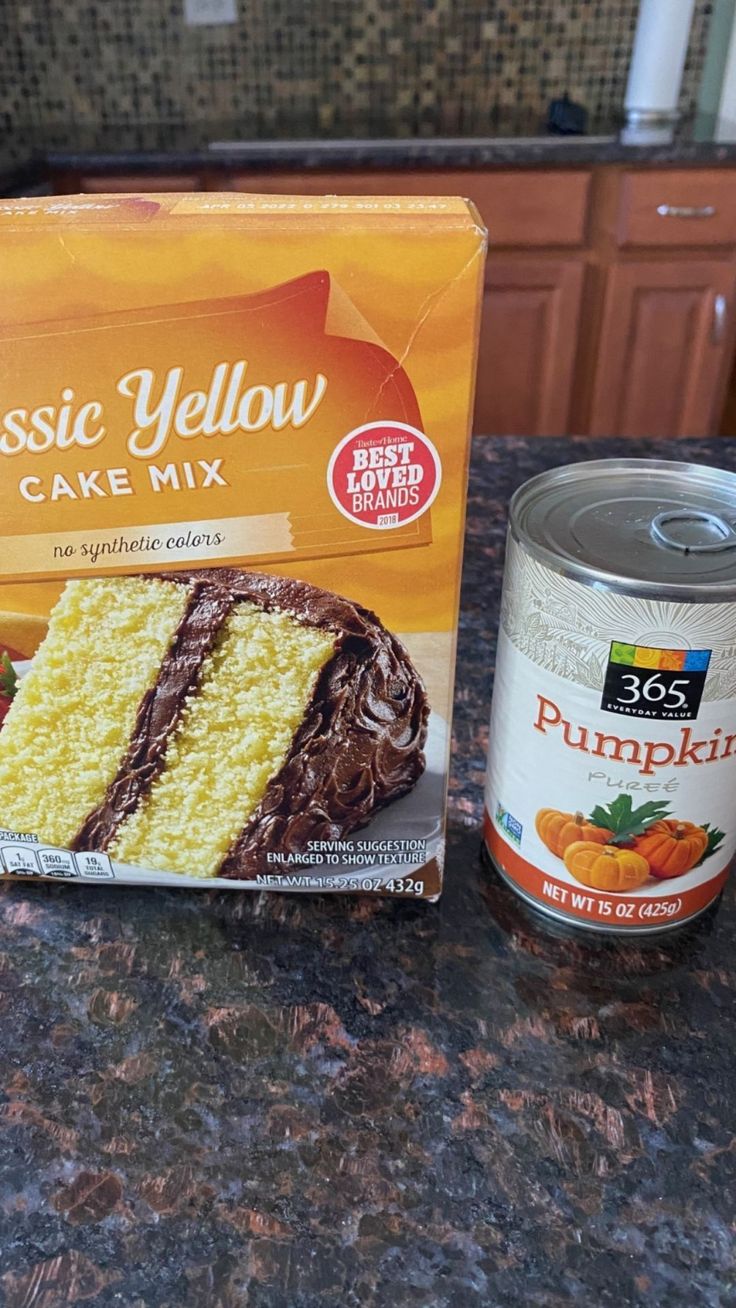 a can of cake mix next to a box of pumpkin yellow cake mix on a kitchen counter