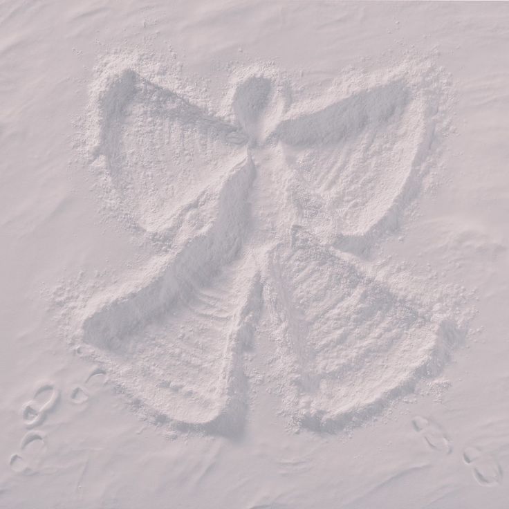 an angel drawn in the snow with footprints