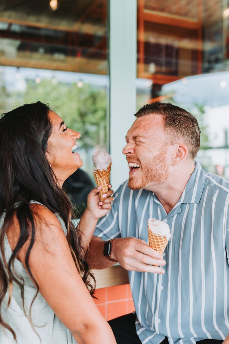 Couple laughing while holding their ice cream cones. Ice Cream Shop Photo Shoot Couple, Ice Cream Maternity Photoshoot, Engagement Photos With Ice Cream, Ice Cream Maternity Shoot, Ice Cream Date Photoshoot, Ice Cream Couple Photoshoot, Ice Cream Parlor Photoshoot, Coronado Photoshoot, Ice Cream Photoshoot Ideas