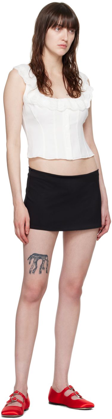 Stretch polyester jersey skirt. · Low-rise · Elasticized waistband · Integrated brief-style underlay Supplier color: Black Black Elastane Lined Skirt, Black Mini Length Elastane Bottoms, Black Lined Skirt In Elastane, Fitted Mini Skirt With Bottom Hem For Summer, Summer Lined Elastane Skirt, Summer Skirt With Lined Elastane, Summer Lined Skirt Made Of Elastane, Summer Skirt With Lining, Fitted Black Short Skirt