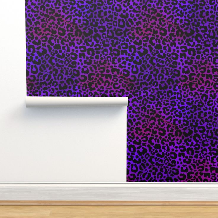 a purple and black animal print wallpaper next to a white door with a wooden floor