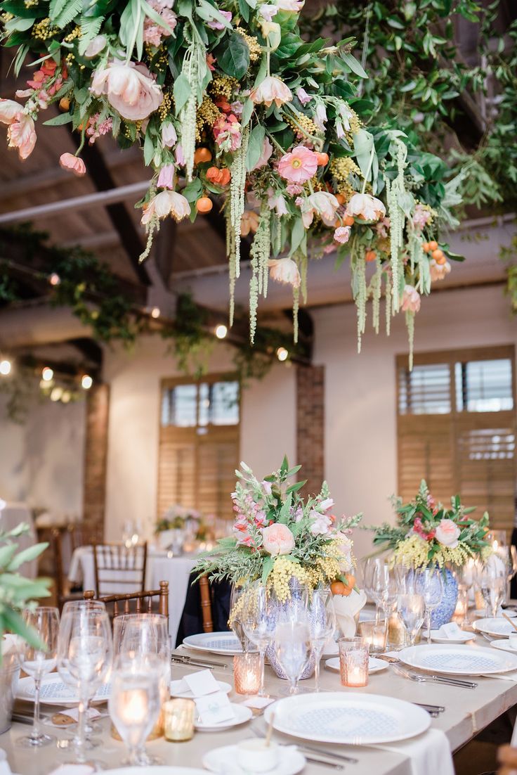 the tables are set with white plates and place settings