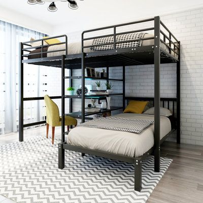 a bunk bed sitting in the middle of a room next to a desk and chair