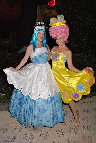 two women dressed up as princesses posing for the camera