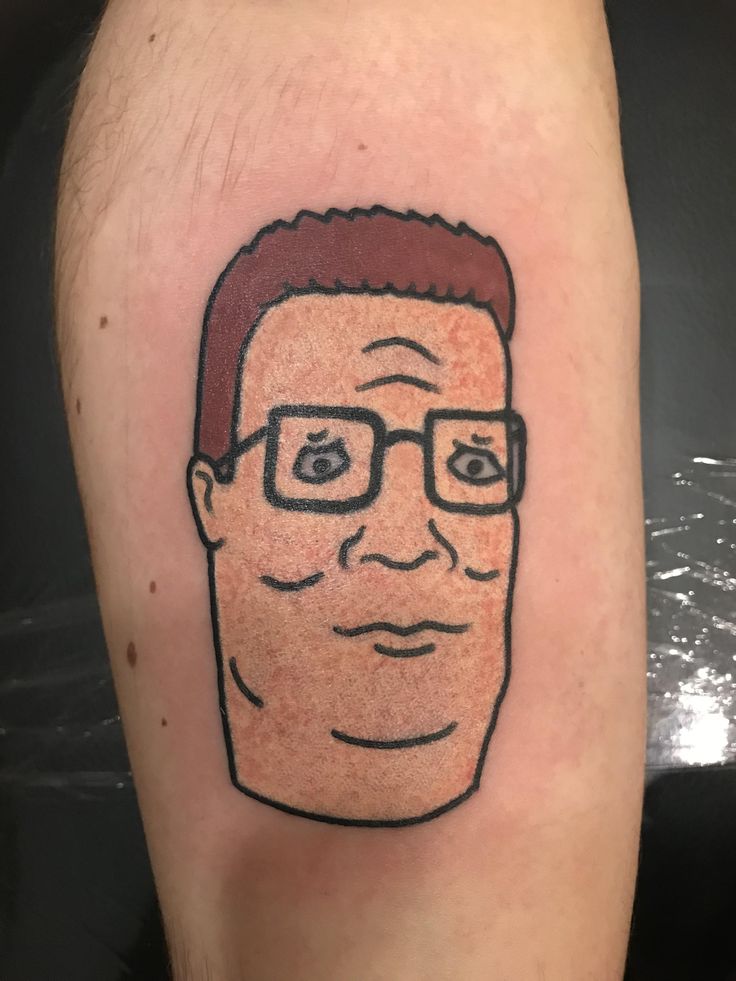 a man's face with glasses on his leg