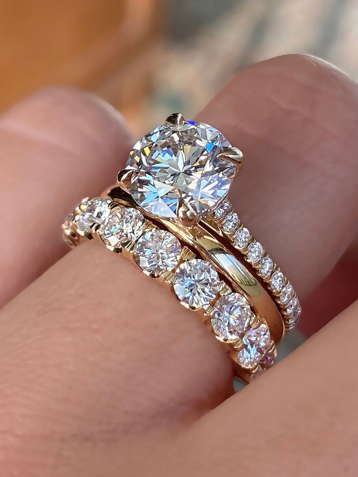 caption:Shown in 14k yellow gold, with 2ct round center diamond option Stackable Bands With Engagement Ring, Moissanite Engagement Ring 4ct, 2.25 Carat Round Engagement Ring, Two Tone Wedding Rings Women, Ring Finger Stack, Pakistani Wedding Ring, Round Wedding Ring Sets Stacked, 10 Year Engagement Ring Upgrade, Curved Wedding Ring Stack