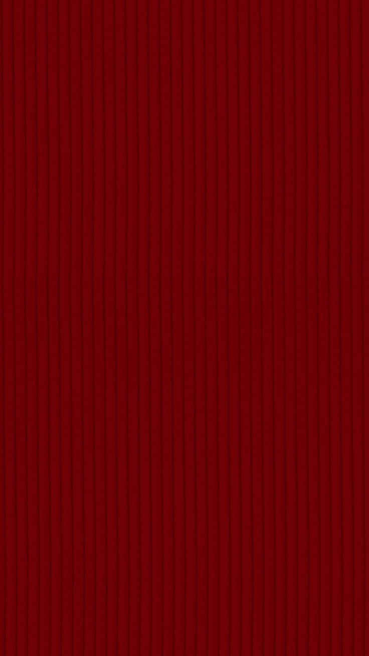 a red wallpaper with vertical lines on it