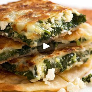 three quesadillas stacked on top of each other with cheese and spinach