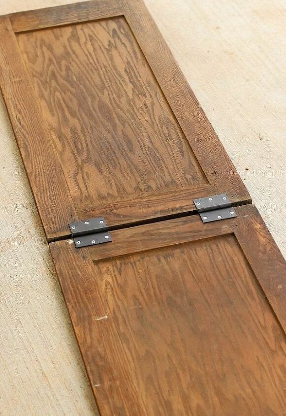 a close up of a wooden door with metal latches on the bottom and sides