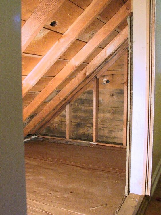 an attic with wood floors and exposed walls