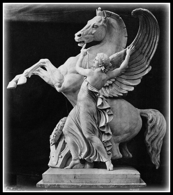 an old photo of a statue of a horse with wings on it's back