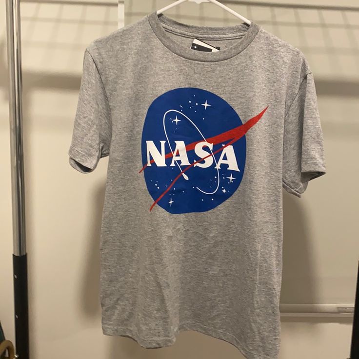 a nasa t - shirt hanging on a clothes rack