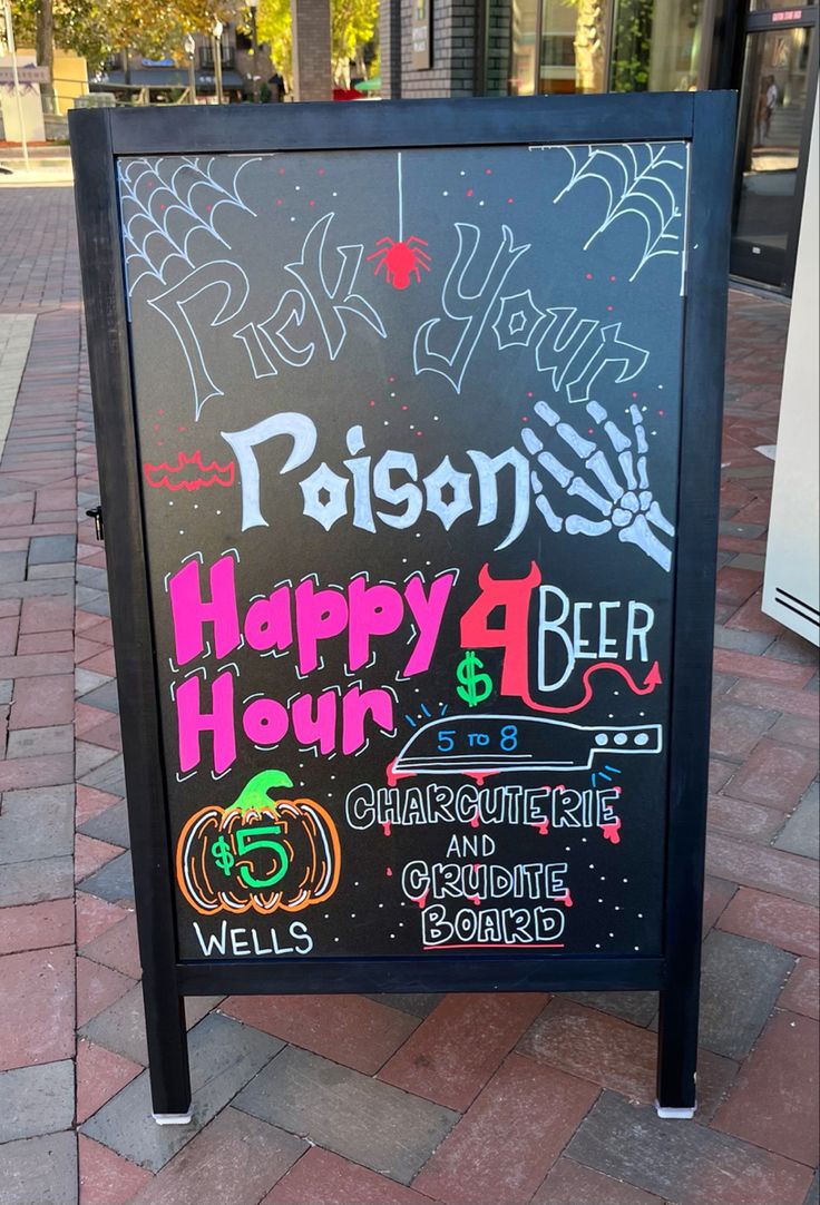 a happy hour sign on the sidewalk in front of a building