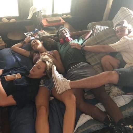 several people laying on top of each other in a living room