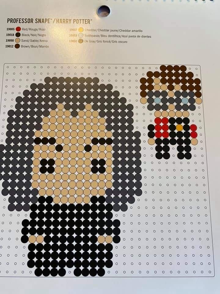 an image of two people made out of perler beads on a sheet of paper