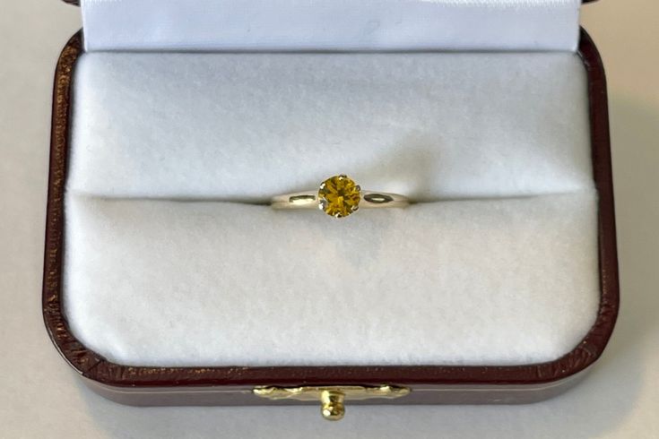 Lovely vintage 14K yellow gold ring featuring a beautiful yellow Sapphire . The gemstone is a bright yellow, round cut, and weighs an estimated .46 carats. The setting is lovely, 6 prong raised ring head. Stunning piece of fine Mid-Century era jewelry with September birthstone, circa 1960. ERA - Circa 1960s METAL / MATERIAL - 14k yellow gold, 1 Yellow Sapphire [estimated .46 carats] MARKINGS / HISTORY - 14k with a Crown CONDITION - Good vintage condition. Yellow sapphire is secure in setting and Yellow Gold Topaz Ring With Yellow Sapphire Center Stone, Yellow Sapphire Ring With Center Stone In Yellow Gold, Formal Citrine Rings With Brilliant Cut, 14k Gold Yellow Sapphire Ring, Yellow Gold Ring With Yellow Sapphire Center Stone, Classic Yellow Sapphire Round Rings, Yellow Gold Yellow Sapphire Ring With Center Stone, White Gold Rings With Brilliant Cut Yellow Sapphire, Oval Yellow Diamond Promise Ring