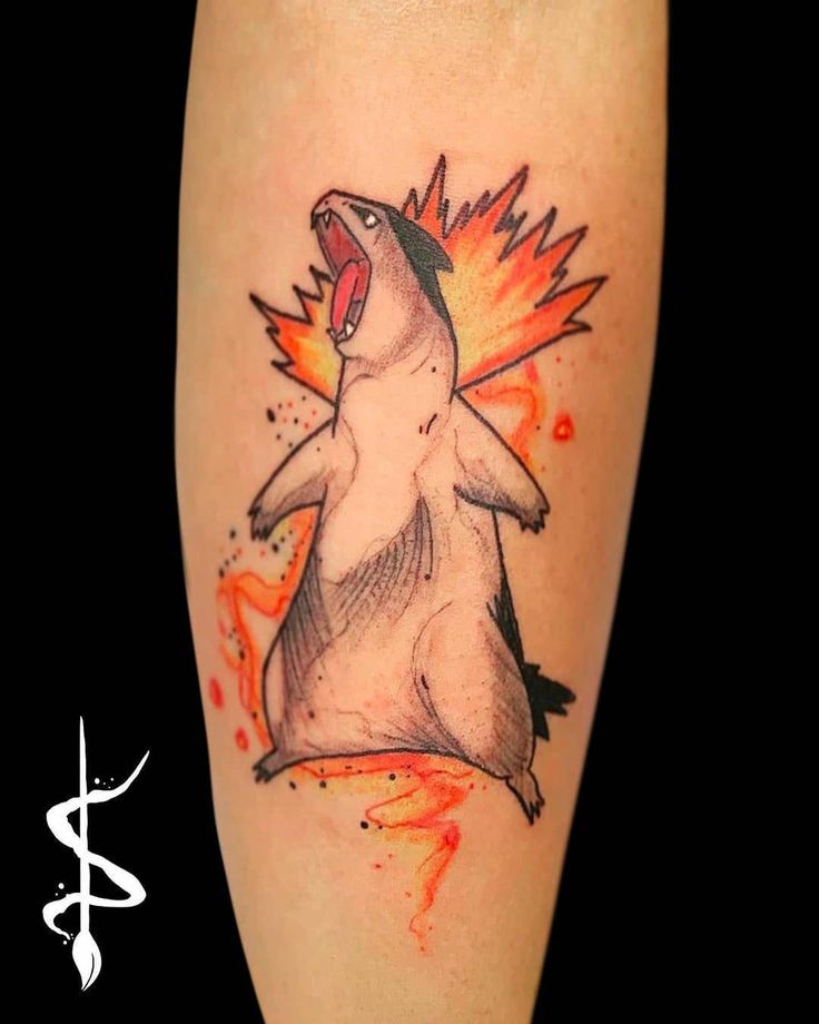 a tattoo with an image of a dog on it's leg and flames coming out of its mouth